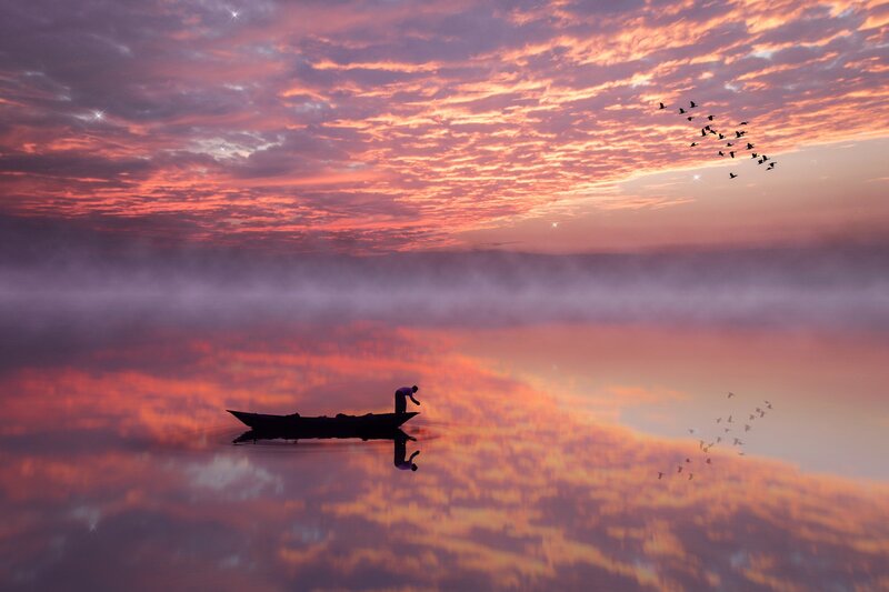 Silhouette of Fisherman in Boat