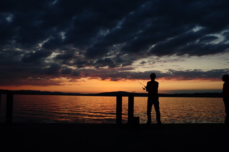 Silhouette of Fisherman — Orange, Dramatic, Sunset