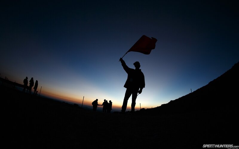 Silhouette of flag bearer at dawn