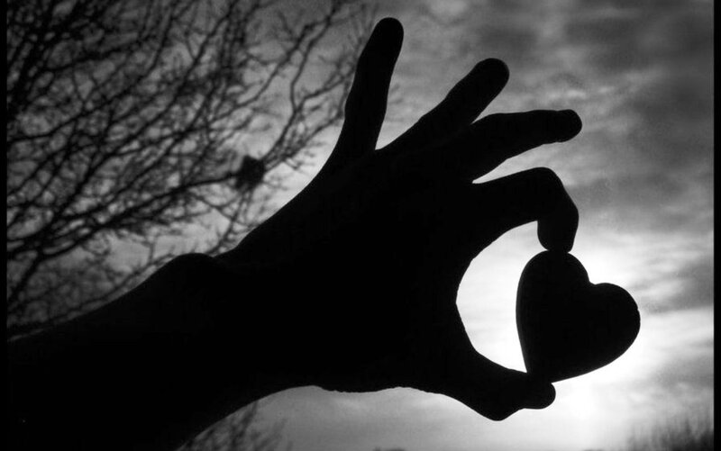 Silhouette of Hand Holding Heart