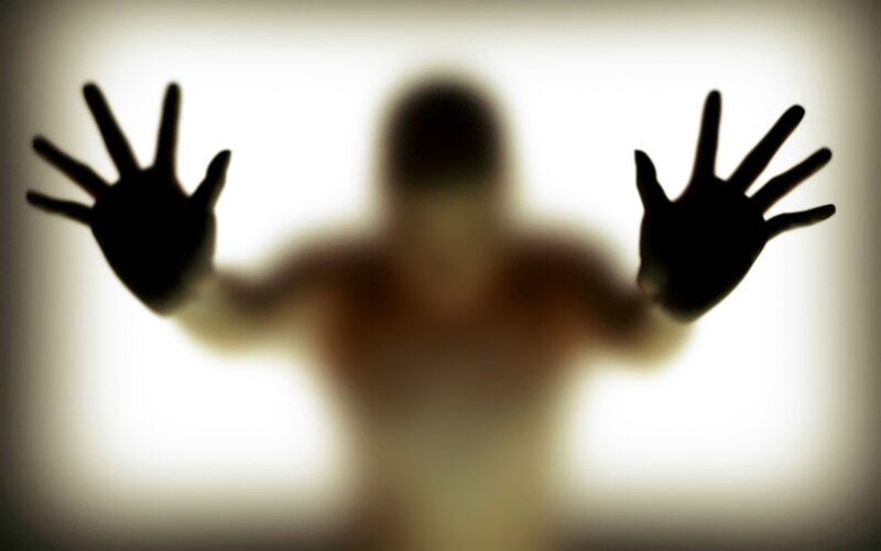 silhouette of hands on glass