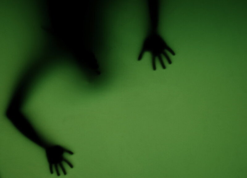 silhouette of hands on green