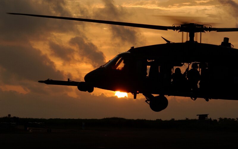 Silhouette of helicopter at sunset
