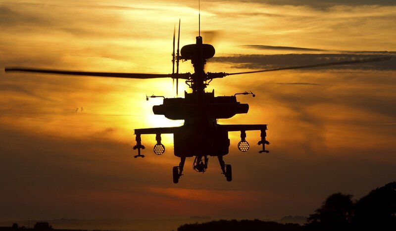 silhouette of helicopter at sunset
