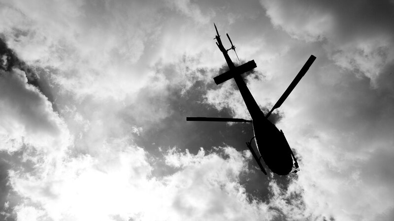 silhouette of helicopter in sky