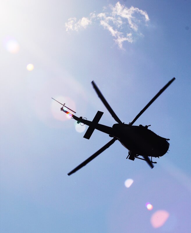 silhouette of helicopter in sky