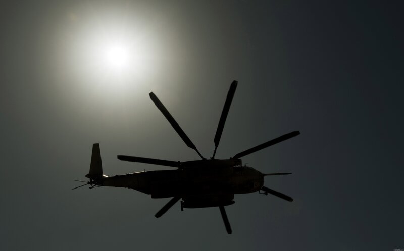 silhouette of helicopter in sky
