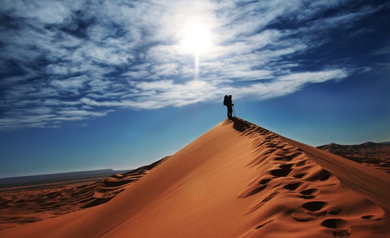 Silhouette of Hiker on Dune