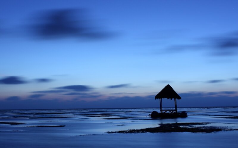Silhouette of hut at dusk
