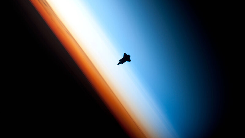 silhouette of jet over earth