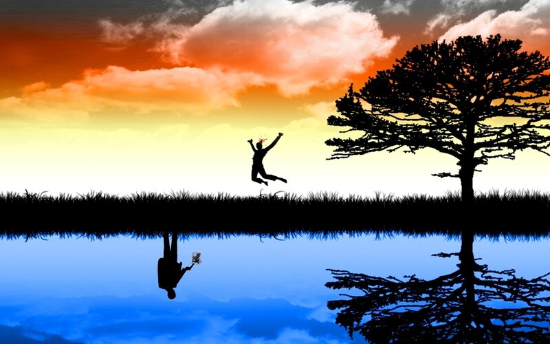 Silhouette of jumping person at sunset