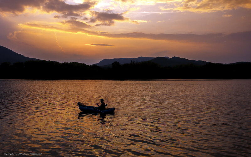 Silhouette of kayaker at sunset