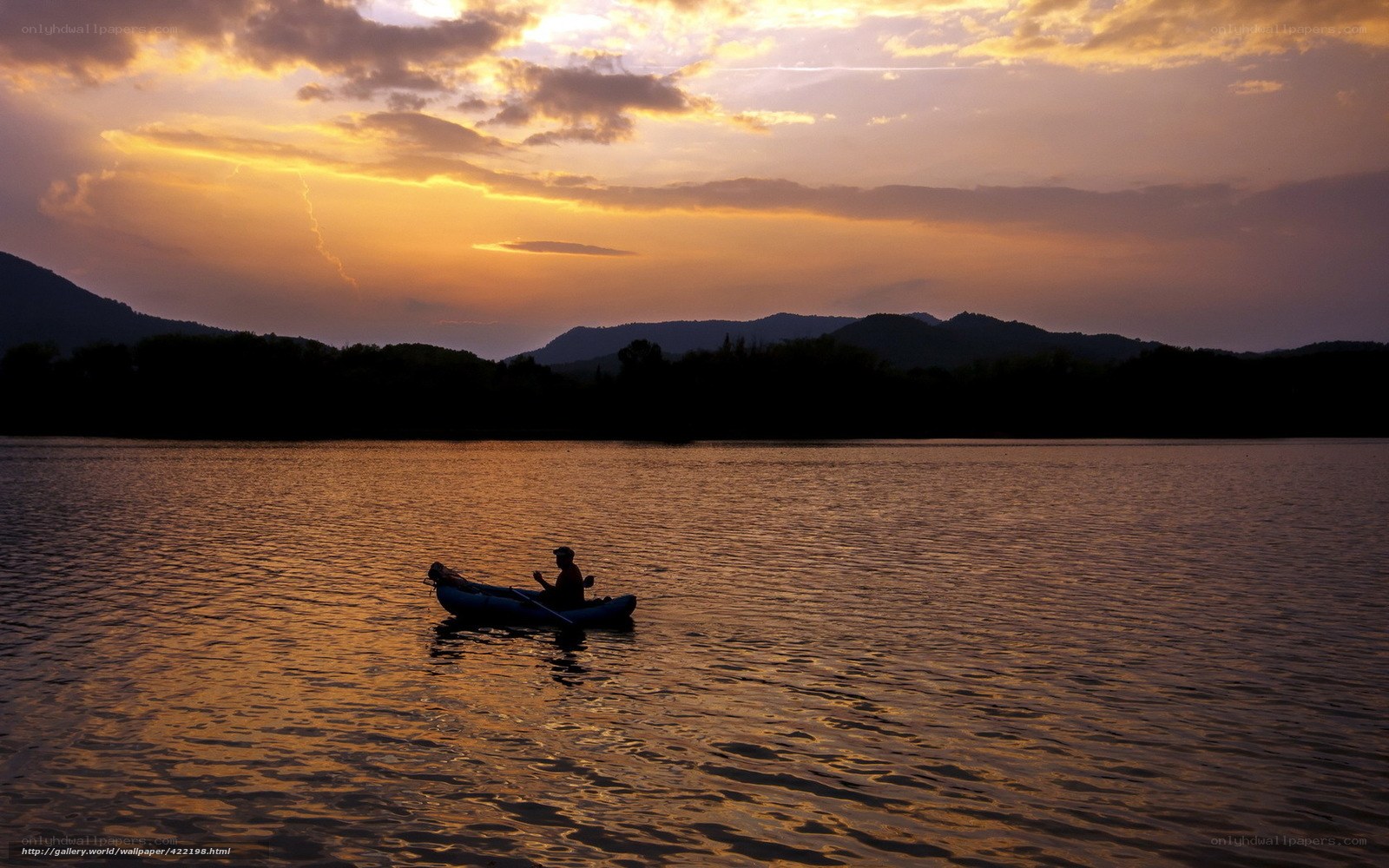 Silhouette of kayaker at sunset