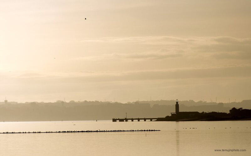 silhouette of lighthouse at dawn