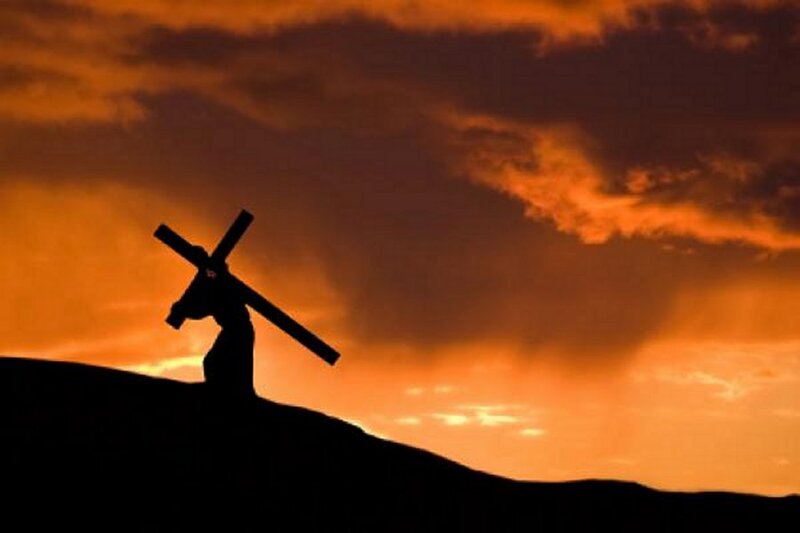 Silhouette of Man Carrying Cross