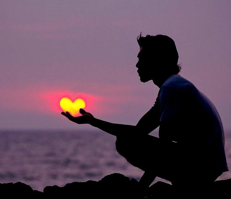 Silhouette of Man Holding Heart