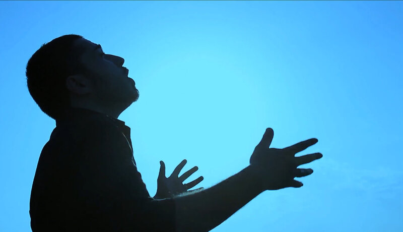 Silhouette of Man Praying — Blue