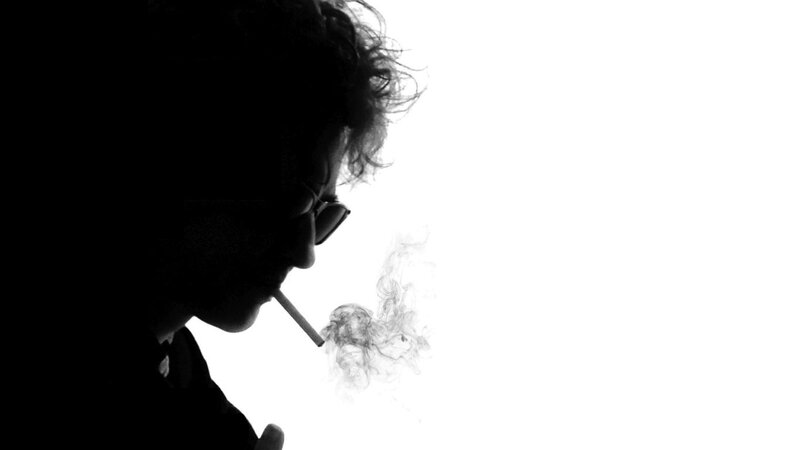 silhouette of man smoking