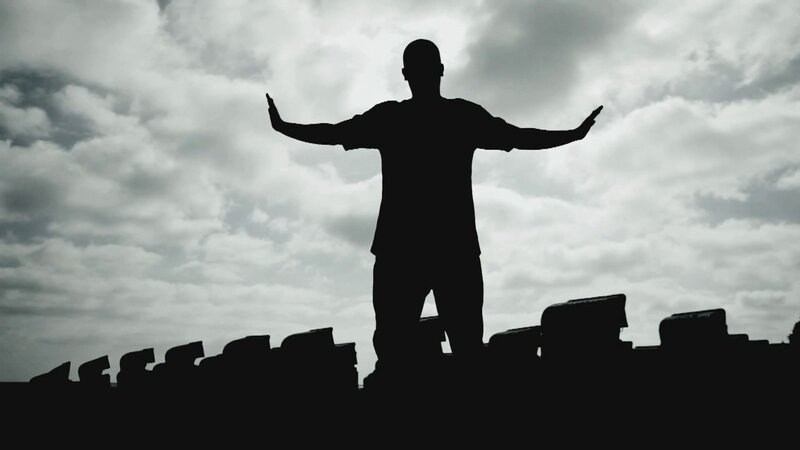 silhouette of man with arms outstretched