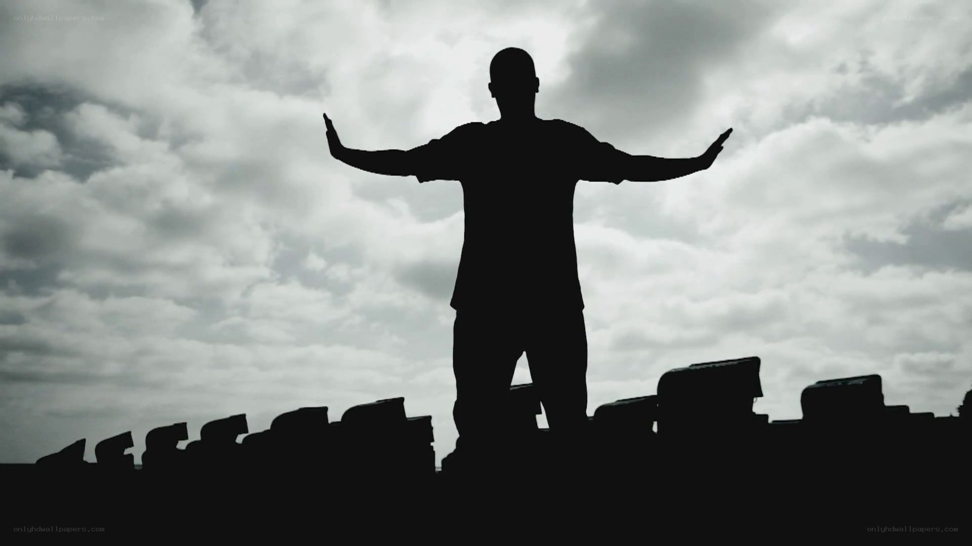 silhouette of man with arms outstretched