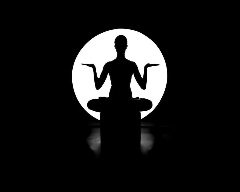 silhouette of meditating person