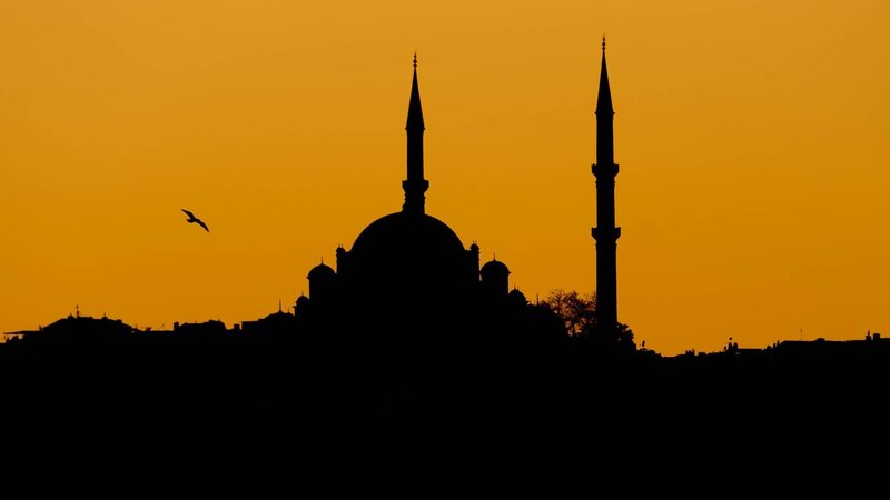 Silhouette of mosque at sunset