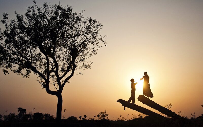 Silhouette of mother and child at sunset