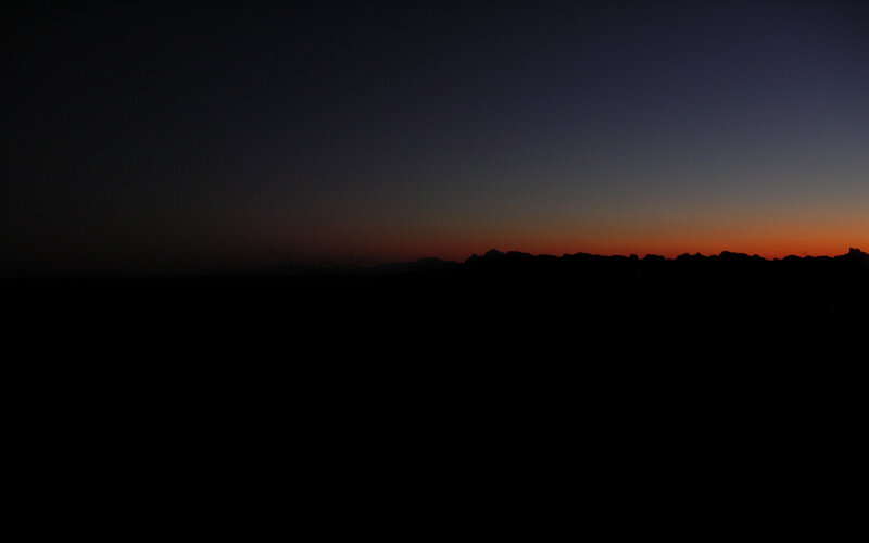 silhouette of mountains at dusk