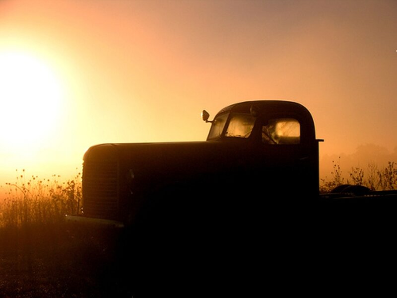 silhouette of old truck at sunrise