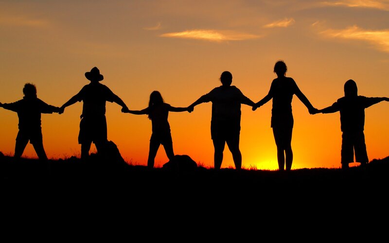 silhouette of people holding hands