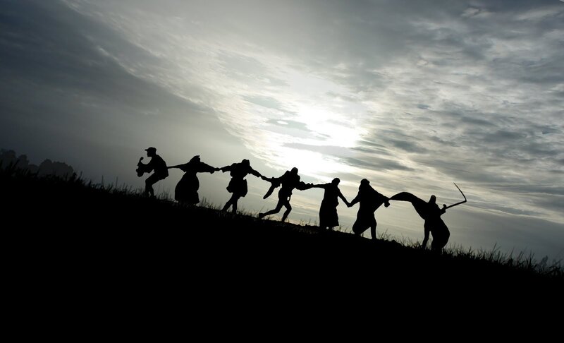 Silhouette of people holding hands