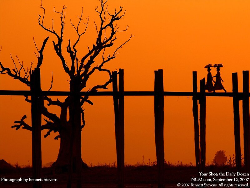 Silhouette of people on bridge