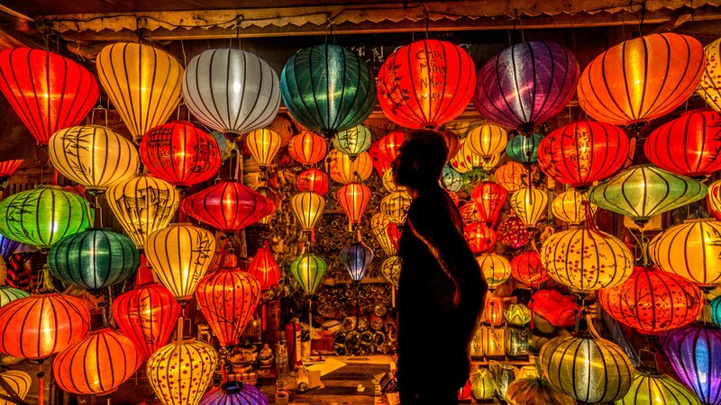 Silhouette of Person Among Lanterns