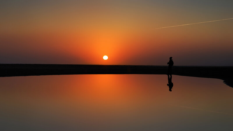 Silhouette of Person at Sunset — Orange, Serene