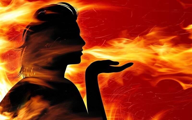silhouette of person breathing fire