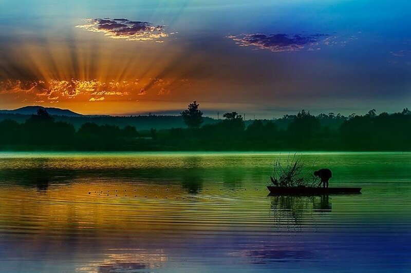 Silhouette of Person in Boat — Blue, Serene, Sunrise