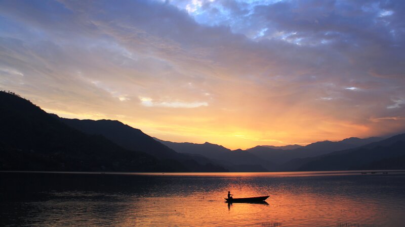 Silhouette of Person in Boat — Orange, Serene, Sunset