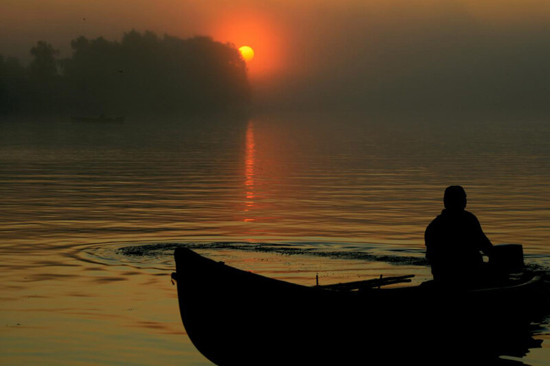 Silhouette of Person in Boat — Orange, Serene