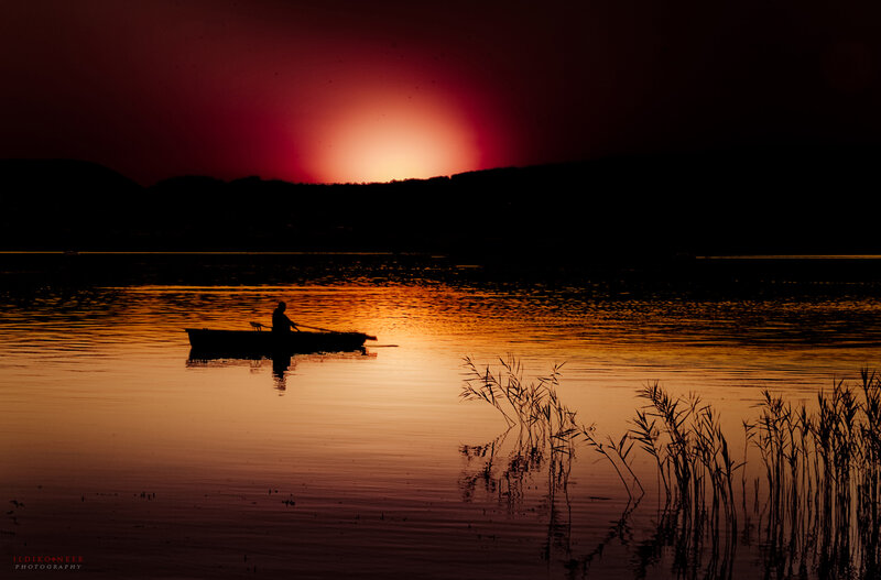 Silhouette of Person in Boat — Red, Dramatic