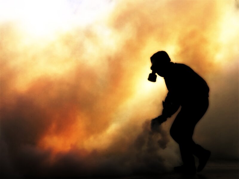 silhouette of person in gas mask