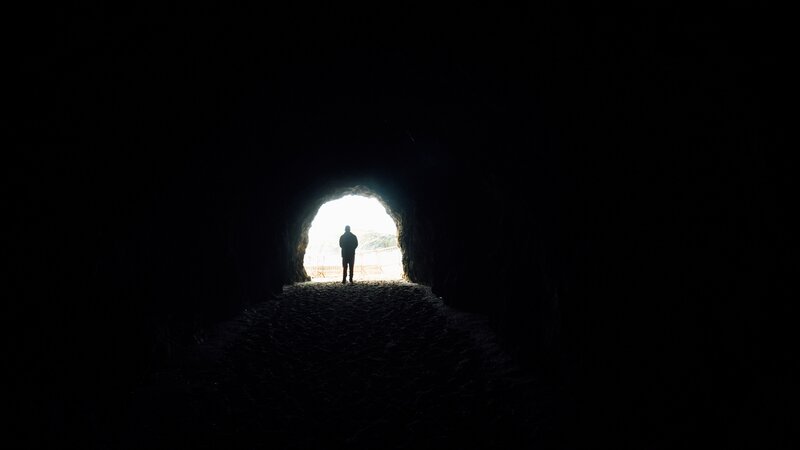 Silhouette of Person in Tunnel — Black, Dramatic, Photograph, Light