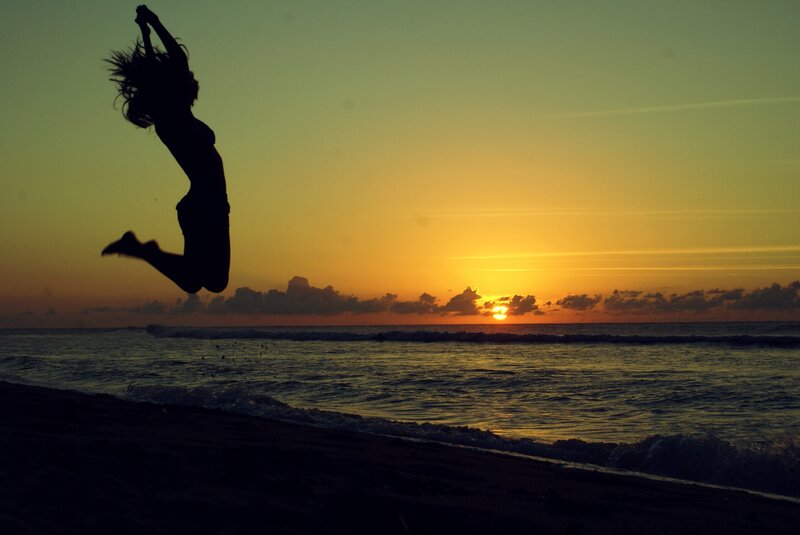 Silhouette of Person Jumping — Orange, Dramatic, Sunset, Photograph, Ocean