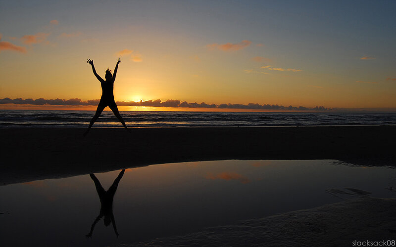 Silhouette of person on beach at sunset