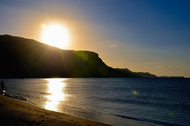 Silhouette of Person on Beach — Blue, Serene, Sunset, Photograph, Sun, Mountain