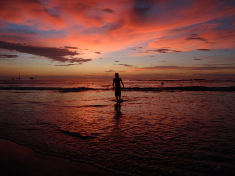Silhouette of Person on Beach — Red, Dramatic