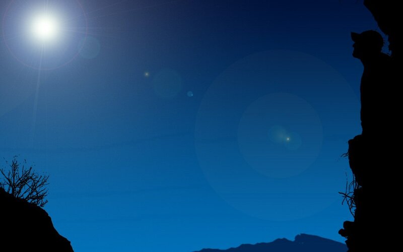 silhouette of person on cliff