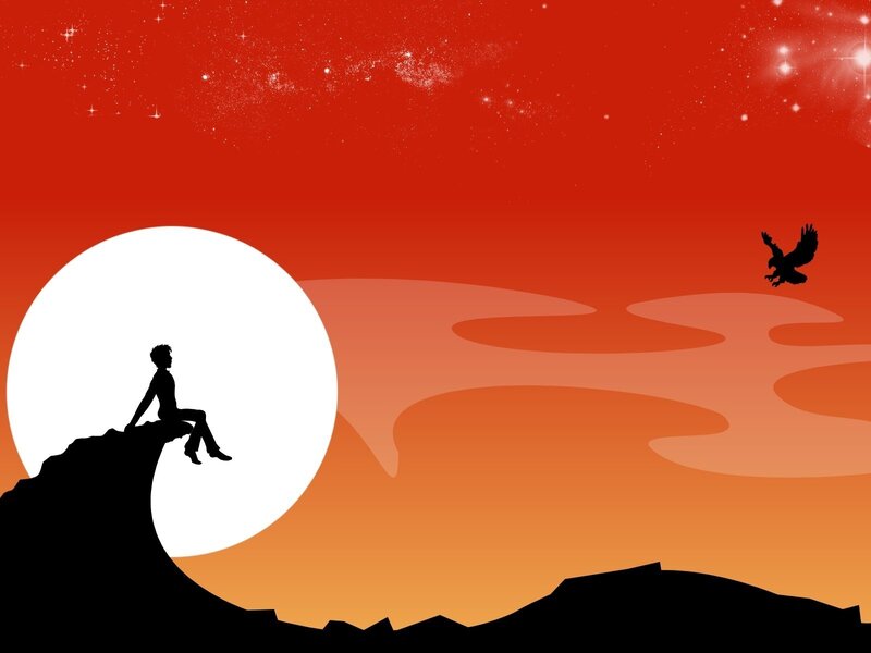 Silhouette of person on cliff