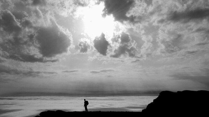 Silhouette of Person on Cliff — Black, Dramatic, Sunset, Photograph