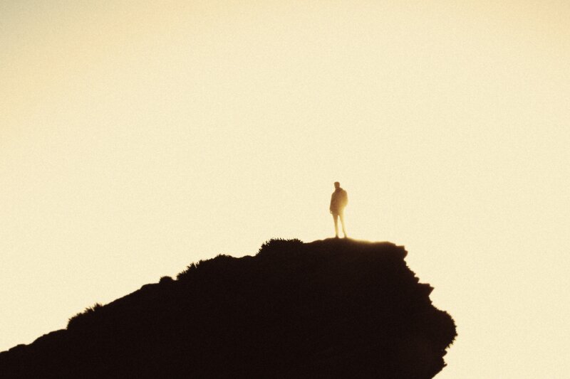 Silhouette of person on cliff