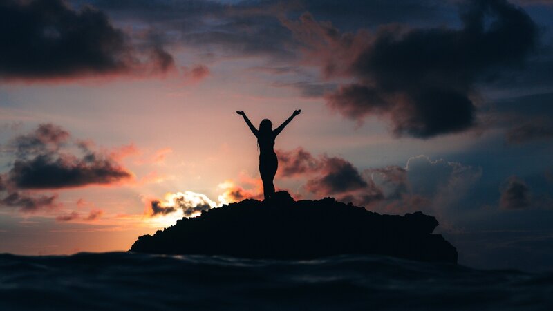 Silhouette of Person on Rock — Orange, Dramatic, Sunset